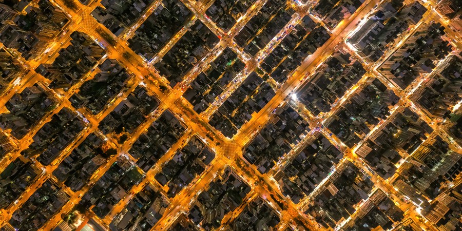 An aerial view of the city streets of Hong Kong at night.