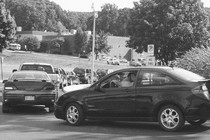 A black-and-white photo of a school car line