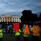 Protesters hold signs that say "No War" outside the White House on June 20.