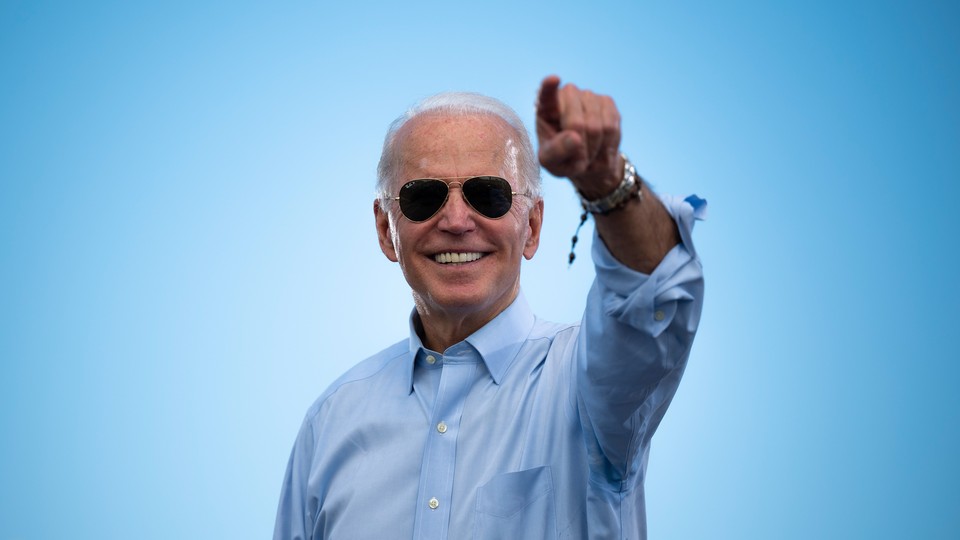 Joe Biden gestures to a crowd before delivering remarks at a drive-in rally in Coconut Creek, Florida.