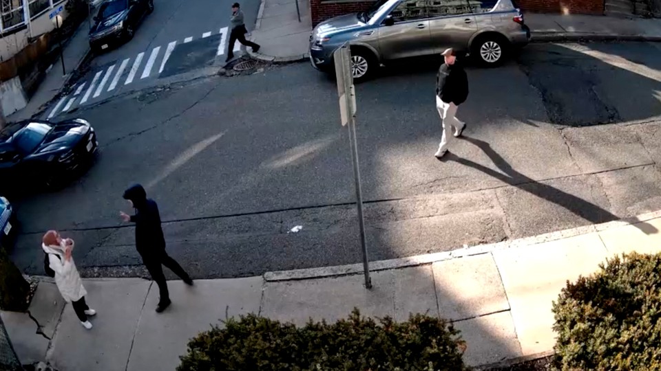 Plainclothes immigration law enforcement officers approach a student in a hijab to detain her