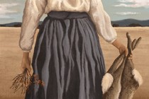 A woman holding dead rabbits