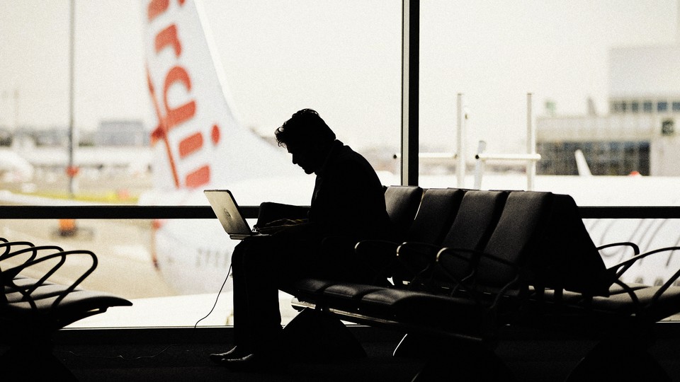Person working on their laptop at the airport