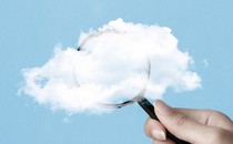 A magnifying glass half-obscured by a cloud