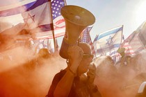 A photo of a man with a bullhorn at a protest of the Israeli government's judicial-overhaul bill