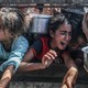 Displaced Palestinians including women and children living in tents receive food distributed by aid organizations in al Mawasi district of Khan Yunis, Gaza on May 30, 2025.