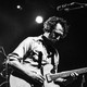 Black-and-white photo of Ryan Miller of Guster playing the guitar