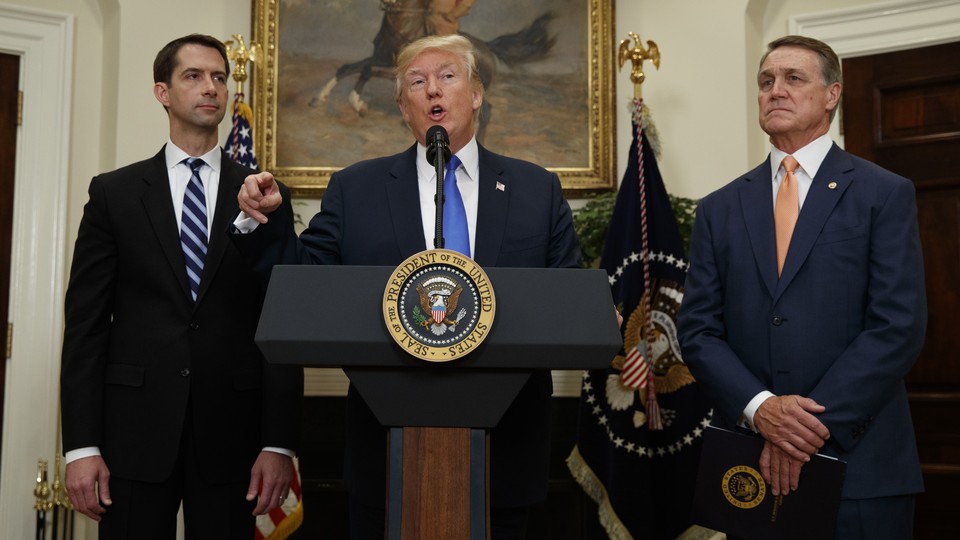 President Trump flanked by Senators Tom Cotton and David Perdue