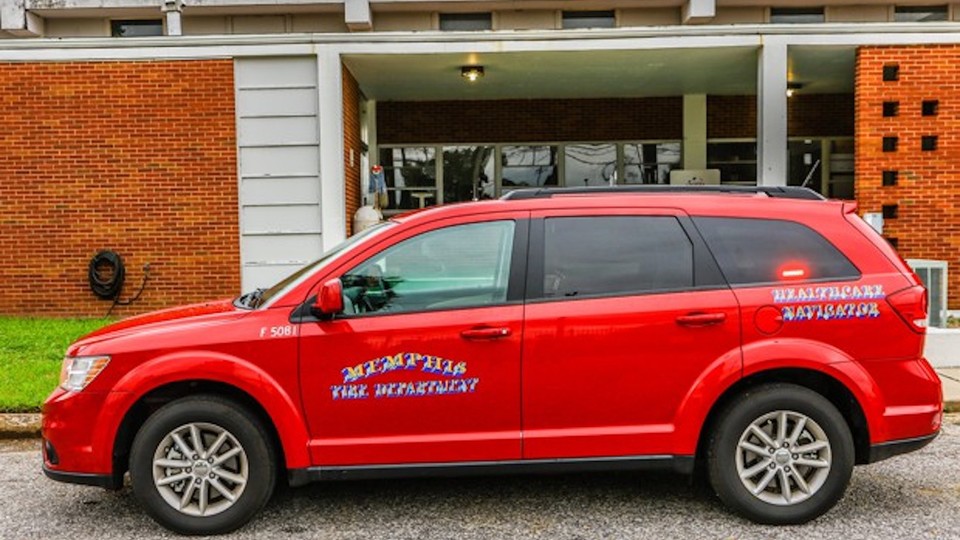 A red SUV with "Memphis Fire Department" and "Healthcare Navigator" printed on the side of the vehicle