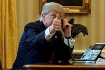 President Donald Trump gives a thumbs-up as he waits to speak by phone with Saudi Arabia's King Salman.