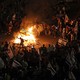 Picture that shows protesters blocking a road and holding national flags as they gather around a bonfire during a rally against the Israeli government's judicial reform in Tel Aviv, Israel, on March 27, 2023