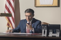 Photo of Speaker Mike Johnson at his office desk talking on the phone