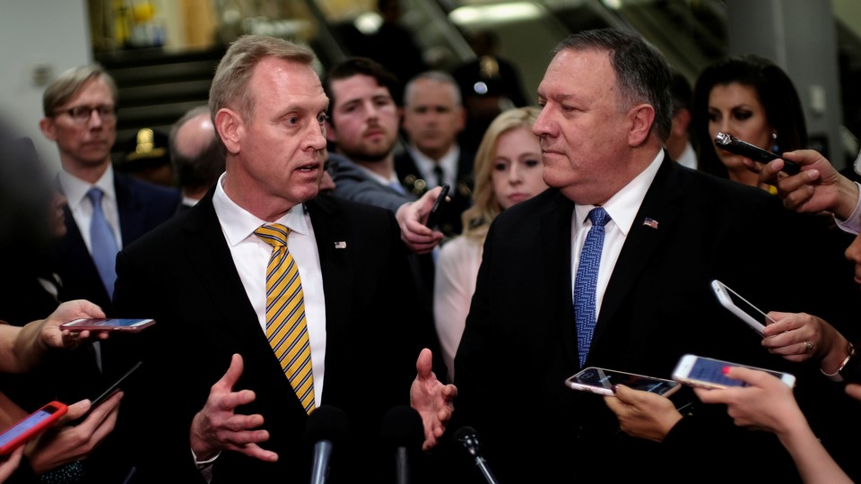 Acting Defense Secretary Patrick Shanahan and Secretary of State Mike Pompeo surrounded by reporters