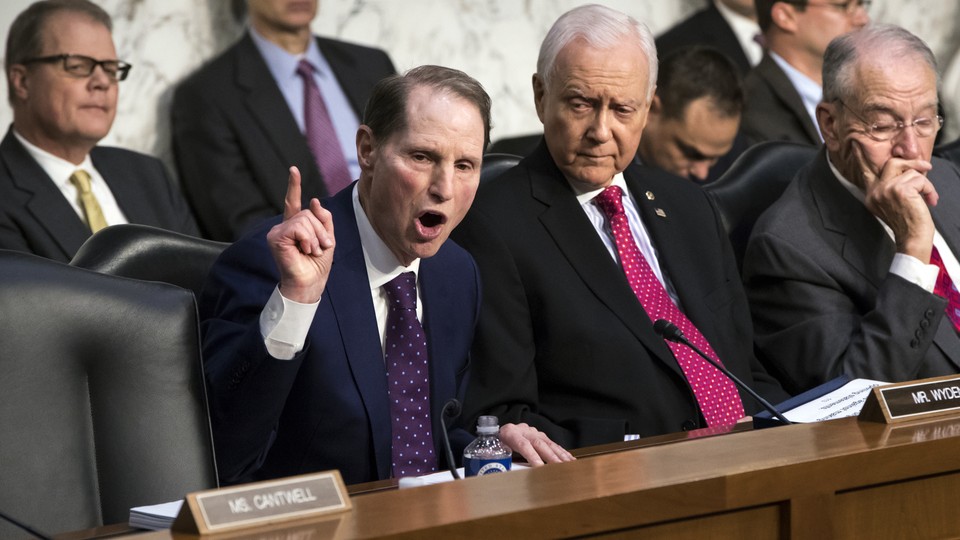 Democratic Senator Ron Wyden of Oregon argues with Republican Orrin Hatch of Utah during a committee debate over taxes.