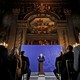 British Prime Minister Boris Johnson gives a speech at the front of an ornate room.
