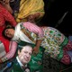 A supporter of Pakistan's Prime Minister Nawaz Sharif passes out on the ground, holding a photo of him.