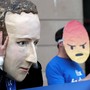 A demonstrator wears a giant mask of Facebook CEO Mark Zuckerberg.