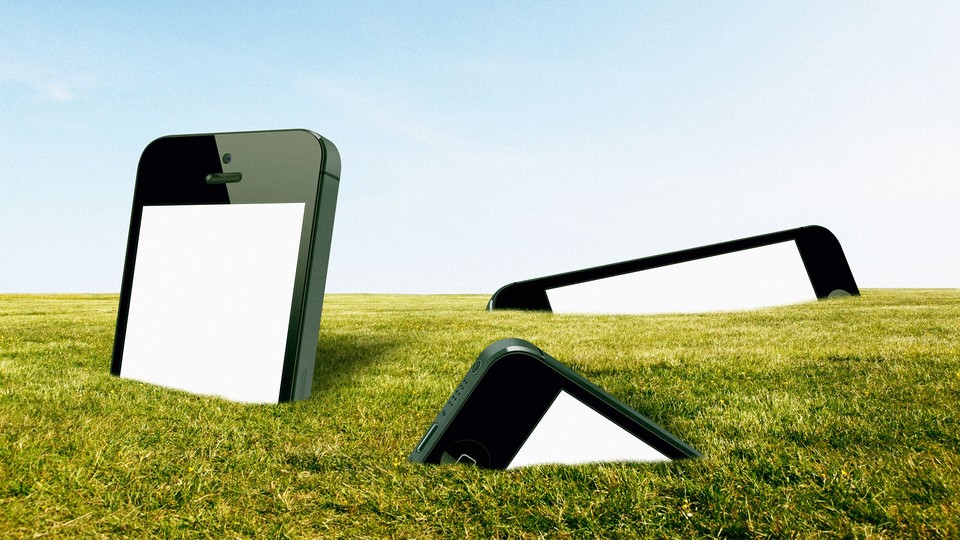 large smartphones stuck in grass