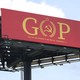 Activist sign replacing the O in GOP with a hammer and sickle