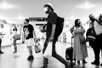 masked people in a bus terminal