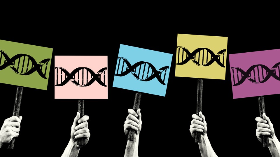 Hands hold up picket signs with DNA on them