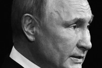 Black-and-white, close-up shot of Vladimir Putin looking resolute in profile