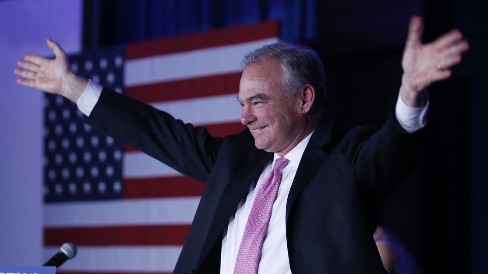 Tim Kaine raises his arms during an election party