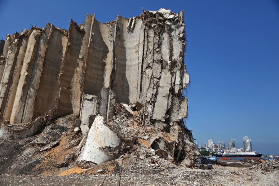 Tremendous damage is seen on large grain silos wrecked by an explosion a year ago.