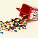 A photo-illustration of a bucket of spilled Lego bricks.