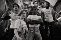 Young Guardian Angels line up on the stairs in a New York City subway station.