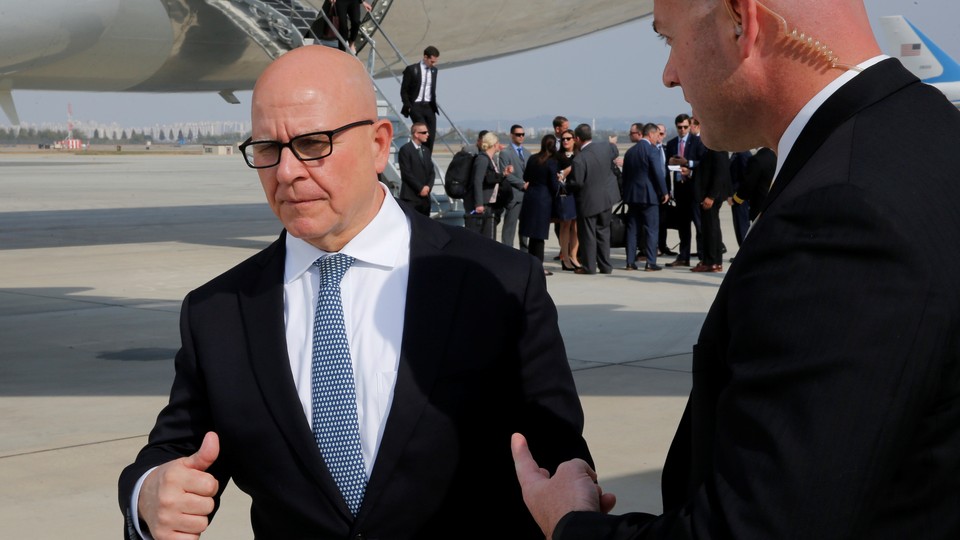 National Security Adviser H.R. McMaster speaks with an aide on the tarmac.