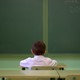 A young boy sitting at his desk