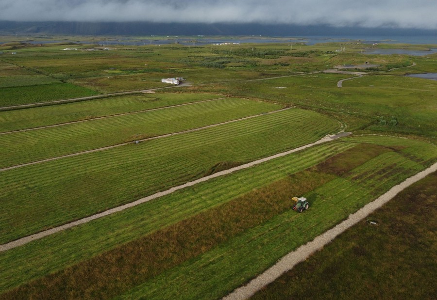 An aerial view of a tractor harvesting hay.