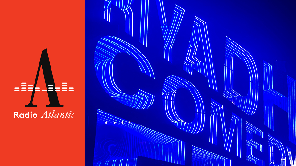 An illuminated neon blue sign reads "Riyadh Comedy Festival"