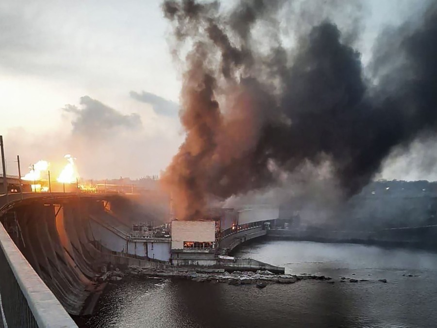 Smoke and fire rise above several parts of a hydroelectric dam.