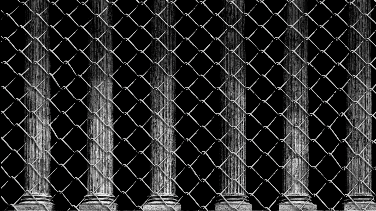 Supreme Court columns behind chain-link fence