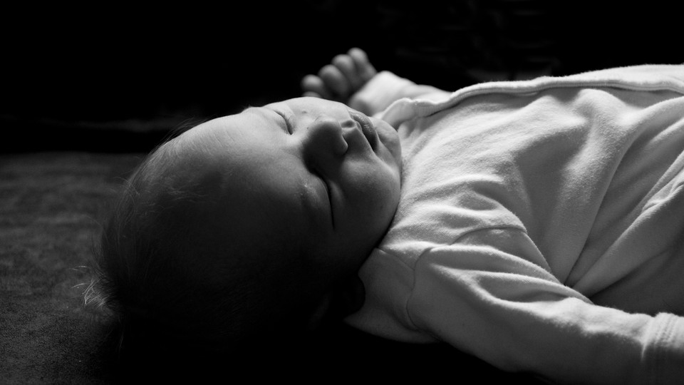 Black-and-white photograph of a baby sleeping