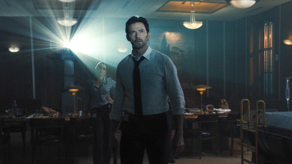 Hugh Jackman looking at a projection in 'Reminiscence'