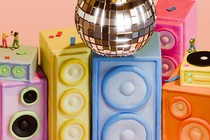 Colorful speakers, a turntable, a disco ball, and tiny people dancing