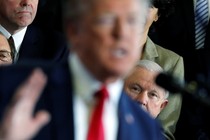 At a March 19 event in New Hampshire, Attorney General Jeff Sessions watches President Trump give a speech about the opioid epidemic.