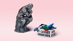 Auguste Rodin's sculpture 'The Thinker' next to a basket of laundry