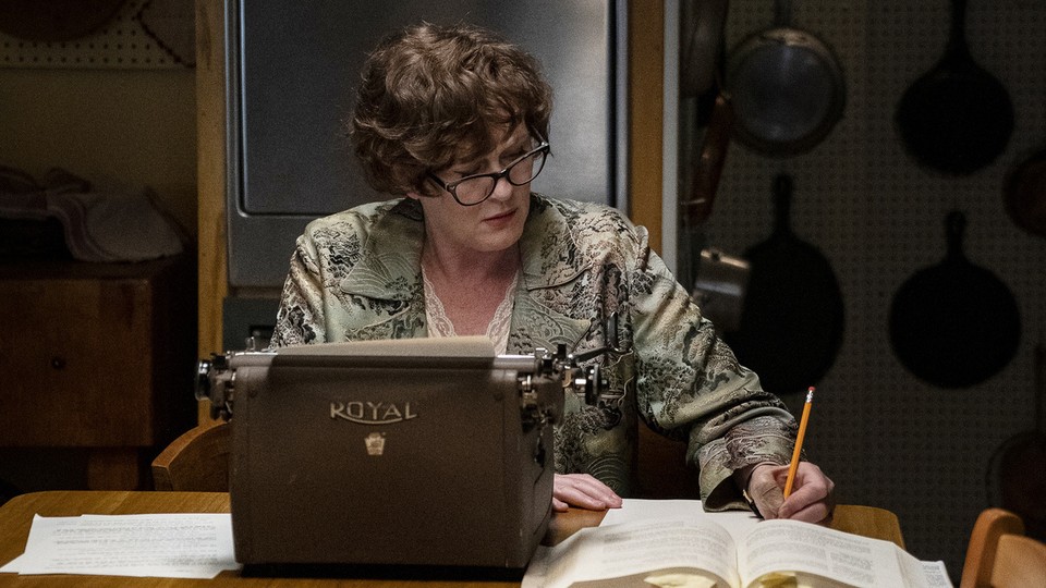Sarah Lancashire as Julia Child, working in front of a typewriter and some papers
