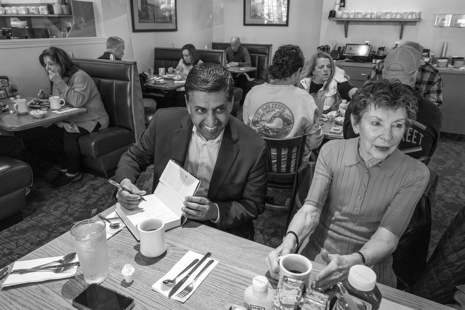 Picture of Ro Khanna signing a copy of his 2022 book for his 9th grade teacher Gigi Raab at Jake's Eatery in Newtown, Pennsylvania