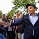 Andrew Yang shakes hands with supporters at a campaign rally.
