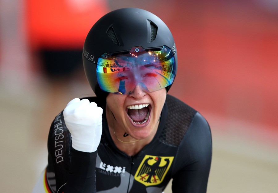 A cyclist celebrates after winning a bronze medal.