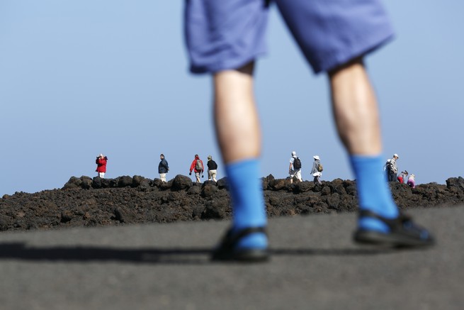 A tourist wearing socks and sandals.