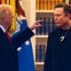 Color photograph of Donald Trump gesturing his left hand toward Elon Musk as they stand talking.