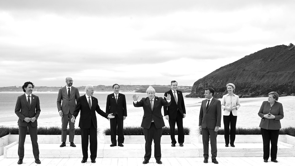 The leaders attending the G7 pose for a photograph on the coast.
