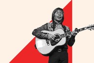 John Denver playing the guitar