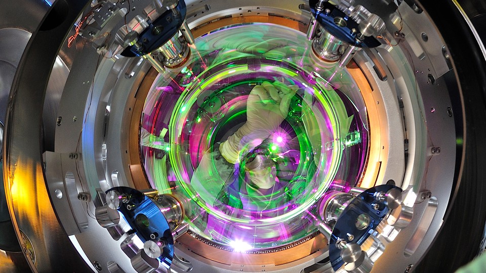 A scientist fiddles with the mirrors at LIGO.